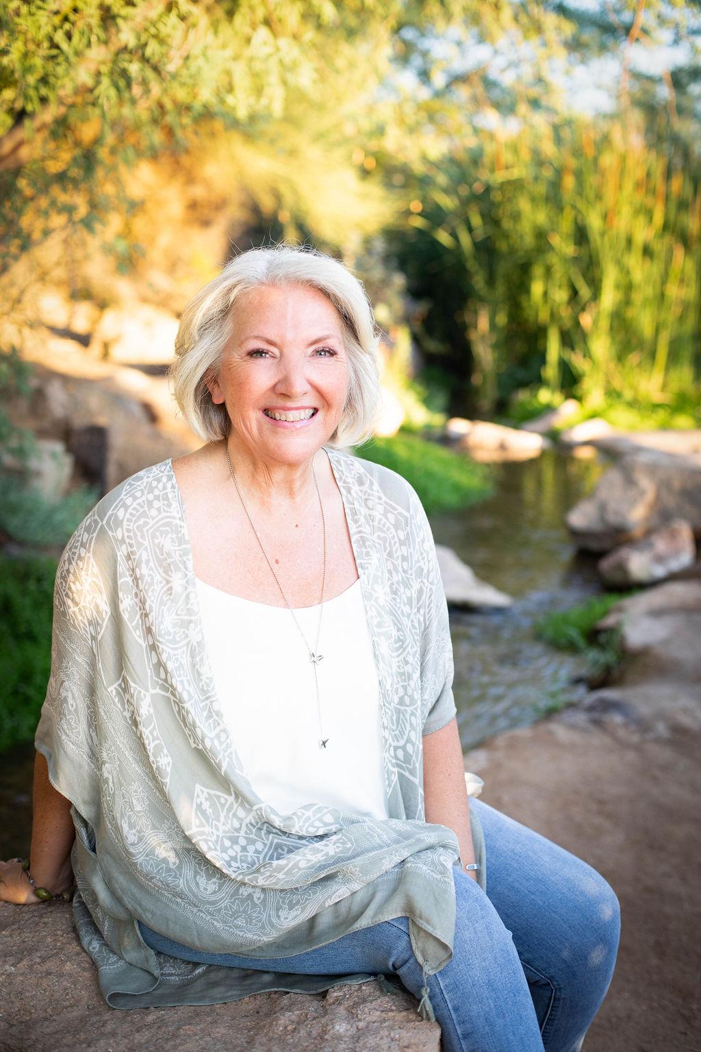 Image of Linda Kozar with a book shelf in background