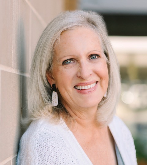 Image of Linda Kozar with a book shelf in background