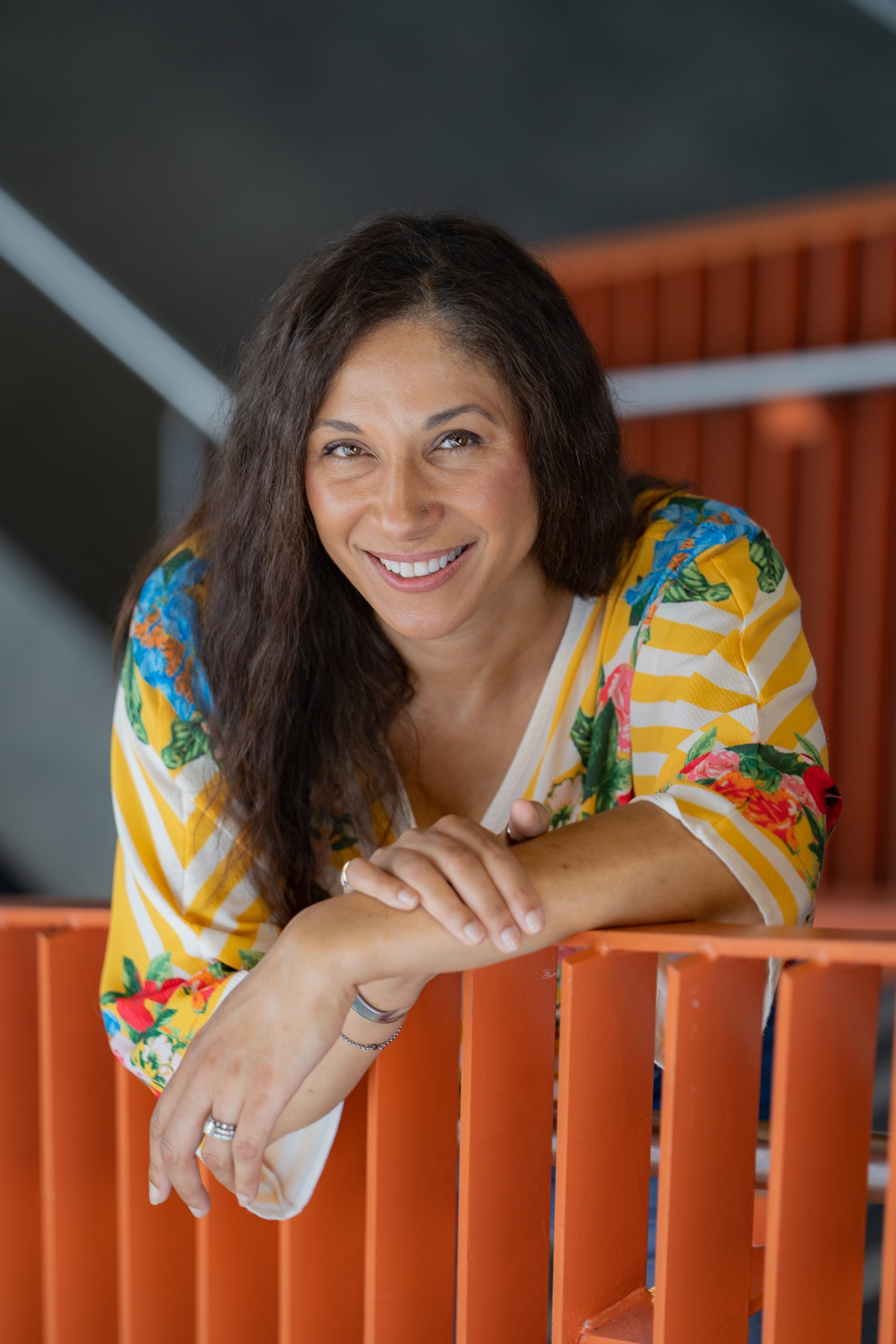 Image of Linda Kozar with a book shelf in background
